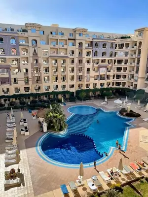 a large hotel with a large pool in front of it at Florenza Blue Sky & Poolview Studio Hurghada in Hurghada