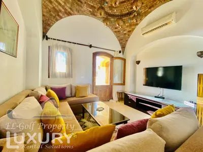 a living room with couches and a flat screen tv at Private Villa Y51 - 3 BedRooms at El-Gouna in Hurghada