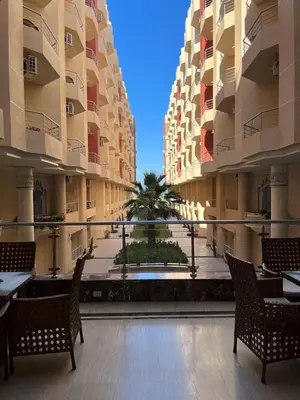 a view of a courtyard in a building with tables and chairs at Casablanca Beach Hurgada in Hurghada