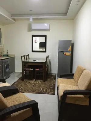 a living room with a table and a refrigerator at Casablanca Beach Hurgada in Hurghada