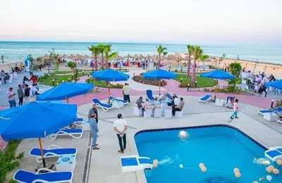 a group of people standing around a pool at the beach at Casablanca Beach Hurgada in Hurghada