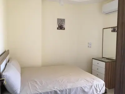 a bedroom with a bed and a mirror and a dresser at Casablanca Beach Hurgada in Hurghada