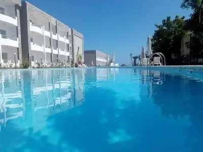 a large pool of blue water in front of a building at Cecilia Resort Chalets- Hurghada in Hurghada