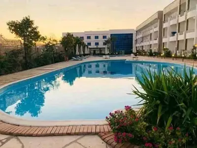 a large swimming pool in front of a building at Cecilia Resort Chalets- Hurghada in Hurghada