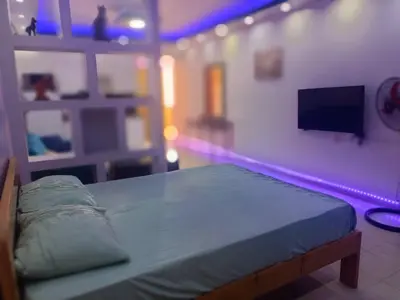 a bedroom with a bed and a tv on a wall at The view studio in Hurghada