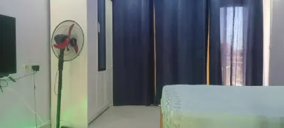 a room with a fan on the wall next to a window at The view studio in Hurghada