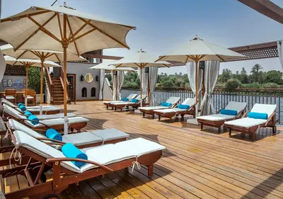 a bunch of lounge chairs and umbrellas on a deck at Dahabeya Molouky Nile Cruise- Every Monday from Luxor- Aswan for 05 nights in Luxor