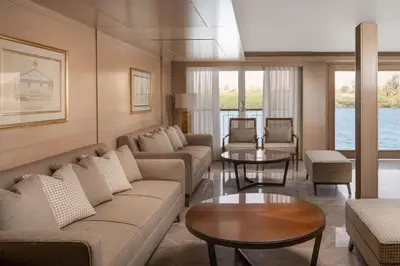 a living room with a couch and a table at Jaz Elite Regent Nile Cruise - Every Monday from Luxor for 07 & 04 Nights - Every Friday From Aswan for 03 Nights in Luxor