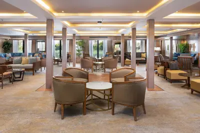 a lobby with tables and chairs in a hotel at Jaz Elite Regent Nile Cruise - Every Monday from Luxor for 07 & 04 Nights - Every Friday From Aswan for 03 Nights in Luxor