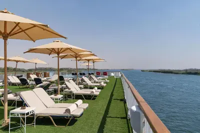 a row of lounge chairs and umbrellas on a pier at Jaz Viceroy Nile Cruise - Every Saturday from Luxor for 07 & 04 Nights - Every Wednesday From Aswan for 03 Nights in Luxor