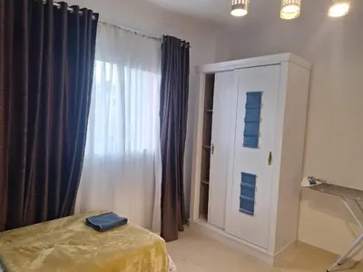 a bedroom with a bed and a window with curtains at new marina heart of Hurghada in Hurghada