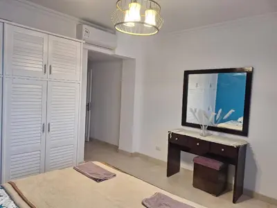 a room with a desk and a mirror on the wall at new marina heart of Hurghada in Hurghada