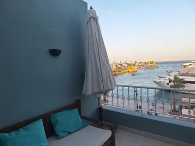 a room with a balcony with a view of the water at new marina heart of Hurghada in Hurghada