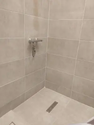 a bathroom with a shower with a tile wall at la vi -panorama sea in Hurghada