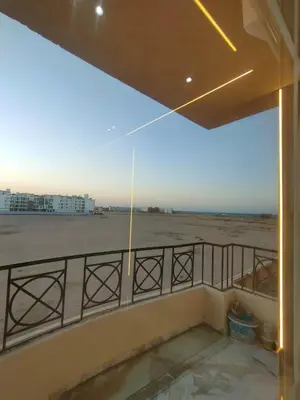 a balcony with a view of the beach at la vi -panorama sea in Hurghada
