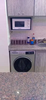 a kitchen with a microwave and a dishwasher at la vi -panorama sea in Hurghada