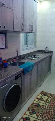 a kitchen with a sink and a washing machine at la vi -panorama sea in Hurghada