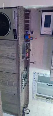 a corner of a kitchen with a wall with a microwave at la vi -panorama sea in Hurghada