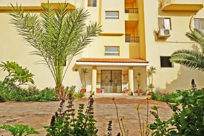 an external view of a building with plants at Modern Mountain View on The Touristic Promenade in Hurghada