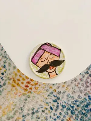 a rock with a painting of a woman on a plate at Modern Mountain View on The Touristic Promenade in Hurghada