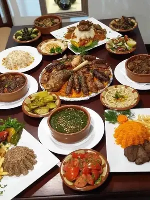 a table full of different types of food on plates at One Love Guesthouse & Restaurant in Luxor