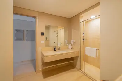 a bathroom with a sink and a shower at Jazzy 1BDR w Outdoor Pool View Terrace Free Pool & Beach Access in Hurghada
