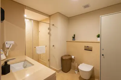 a bathroom with a toilet and a sink and a shower at Jazzy 1BDR w Outdoor Pool View Terrace Free Pool & Beach Access in Hurghada