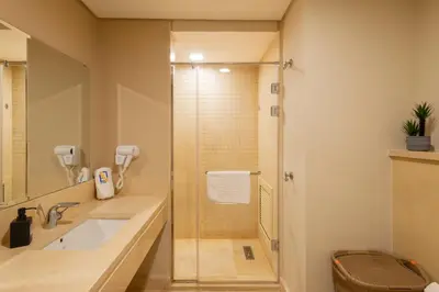a bathroom with a shower and a sink at Jazzy 1BDR w Outdoor Pool View Terrace Free Pool & Beach Access in Hurghada