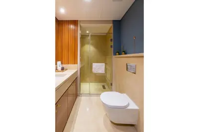a bathroom with a toilet and a shower at Elegant & Edgy 2 BR w Beach & Pool Mangroovy in Hurghada