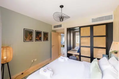 a bedroom with a bed and a desk at Elegant & Edgy 2 BR w Beach & Pool Mangroovy in Hurghada