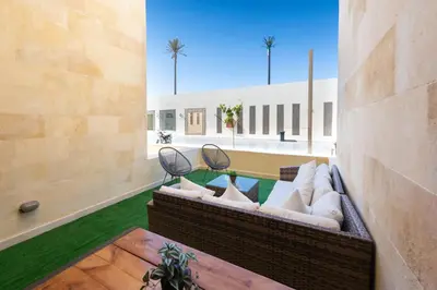 a living room with two couches and a table at Elegant & Edgy 2 BR w Beach & Pool Mangroovy in Hurghada
