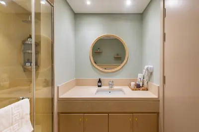 a bathroom with a sink and a mirror at Elegant & Edgy 2 BR w Beach & Pool Mangroovy in Hurghada