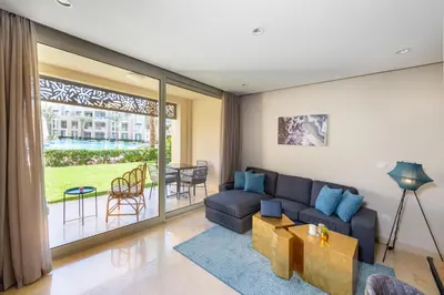 a living room with a couch and a table at Elegant & Edgy 2 BR w Beach & Pool Mangroovy in Hurghada