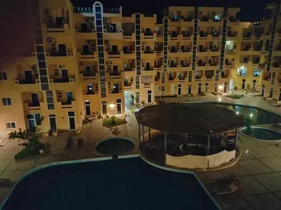 an overhead view of a building with a swimming pool at night at Tiba Resort F22 Near to ElGouna in Hurghada
