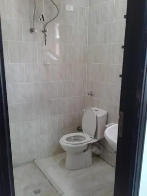 a bathroom with a toilet and a sink and a shower at Tiba Resort F22 Near to ElGouna in Hurghada