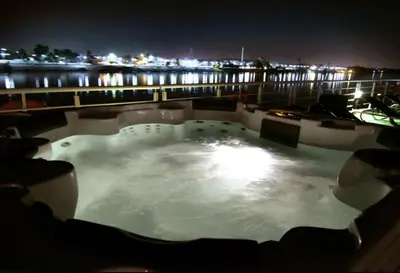 a hot tub on a balcony at night at Le Fayan Nile Cruise - Every Monday from Luxor for 4 & 7 Nights, and every Friday from Aswan for 3 & 7 Nights in Luxor