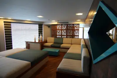 a living room with a couch and a table at Le Fayan Nile Cruise - Every Monday from Luxor for 4 & 7 Nights, and every Friday from Aswan for 3 & 7 Nights in Luxor