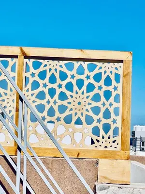 a wooden fence with a pattern on it at Cozy Apartment in Qadd el-Barûd