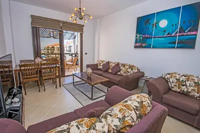 a living room with two couches and a table at Premium sea view 2 bedrooms 2 bathrooms apartment located within Gravity Hotel & Aquapark Hurghada in Hurghada