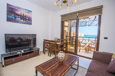 a living room with a couch and a table at Premium sea view 2 bedrooms 2 bathrooms apartment located within Gravity Hotel & Aquapark Hurghada in Hurghada