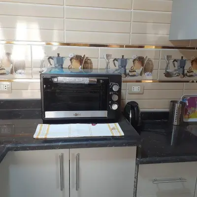 a microwave sitting on top of a kitchen counter at Hossam Deluxe Apartment El Hadaba Sheraton in Hurghada