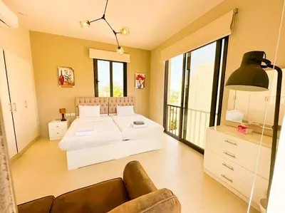 a bedroom with a white bed and a couch at Luxury 3 bedrooms town house in Hurghada