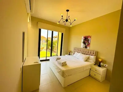 a bedroom with a bed and a large window at Luxury 3 bedrooms town house in Hurghada