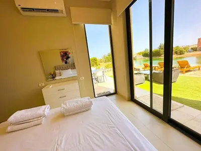 a bedroom with a bed and a view of a patio at Luxury 3 bedrooms town house in Hurghada