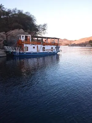 a boat is docked in a body of water at Houseboat Hotel and Nile Cruises Zainoba in Aswan
