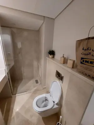 a bathroom with a toilet and a glass shower at MCJ Luxury 2 Bedrooms Apartment in Hurghada