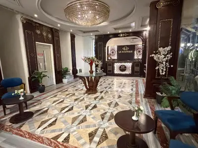 a lobby with a marble floor with tables and chairs at La Boutique Residence in Hurghada