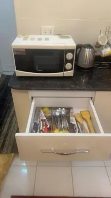 a drawer in a kitchen with a microwave at Hossam Comfort Apartment El Hadaba Hurghada in Hurghada