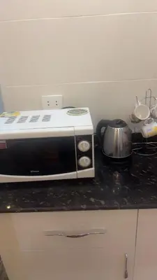 a microwave sitting on top of a kitchen counter at Hossam Comfort Apartment El Hadaba Hurghada in Hurghada