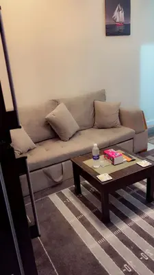 a living room with a couch and a coffee table at Hossam Comfort Apartment El Hadaba Hurghada in Hurghada